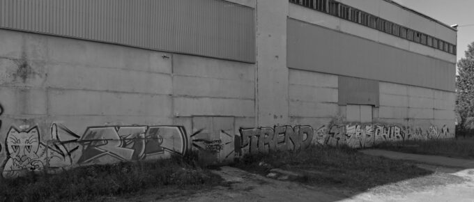Graffiti-covered warehouse with a broken upper window on Celtnieku iela, Olaine